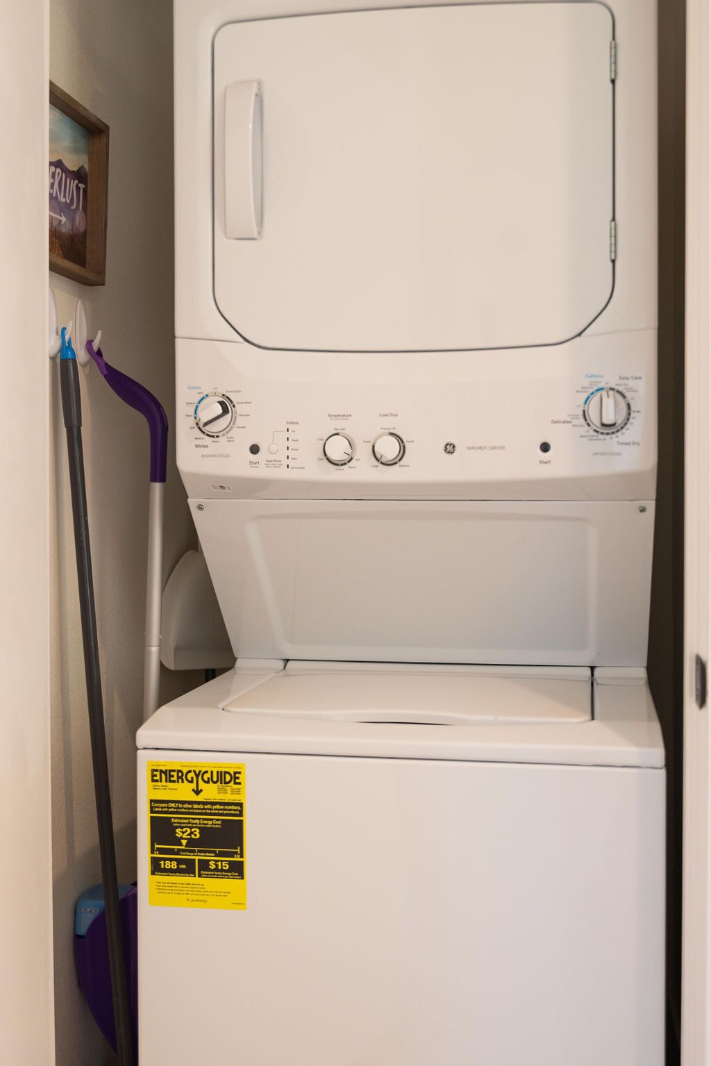 A front-loading washer and dryer unit with a yellow ENERGYGUIDE sticker.