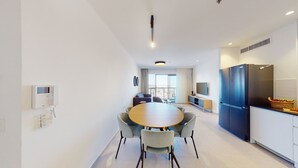 A modern kitchen with a dining area, a large refrigerator, and a built-in oven. - Savyon V.I.E.W - Luxury 3BR w/ Har HaBayit View (Jerusalem)
