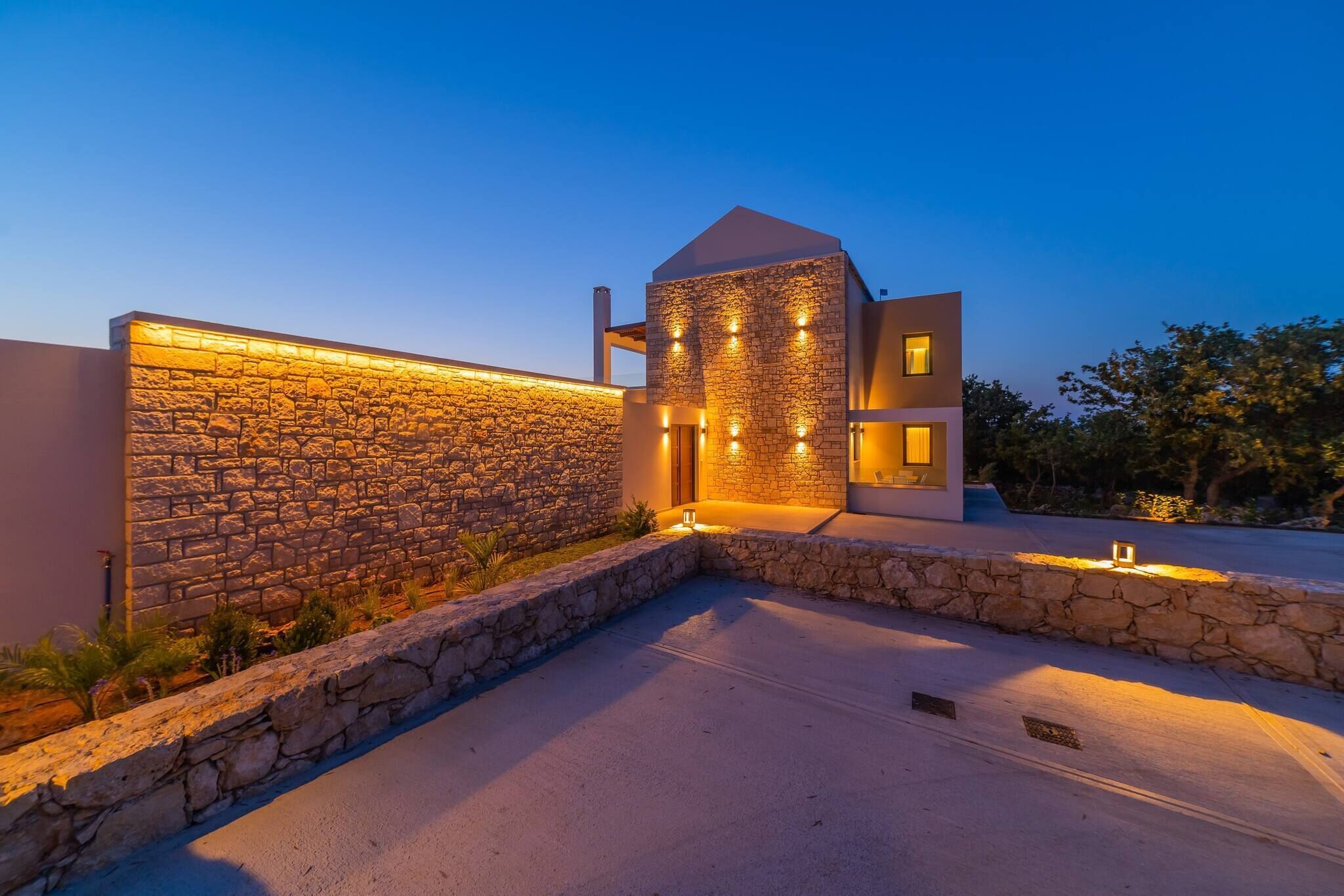 A modern building with a stone facade and a flat roof.