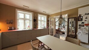 A kitchen with a large island, a dining table, and a view into the dining area.