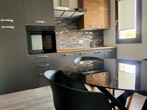 Club Apartment | Private kitchen | Full-sized fridge, cookware/dishes/utensils, dining tables - Suite Apartments i4MORI Porto Pino (Sant'Anna Arresi)