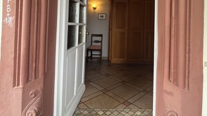 An arched doorway with intricate moldings and a textured ceiling.
