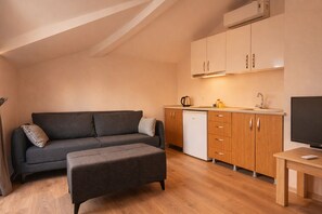 Panoramic Penthouse, City View | Living area | LCD TV