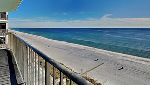 A beach view from a balcony with a railing, a clear sky, and the ocean. - Watercrest #807 | Beach Views + Resort Pool! (Panama City Beach)