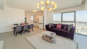 A modern living room with a dining area, large windows, and a city view. - Dreamy  2BDR, Unparalleled Views Of The Old City (Jerusalem)