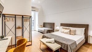 A modern bedroom with two beds, a desk, and a chair. - Domus Partenopea  (Naples)