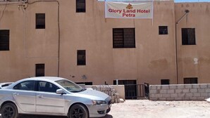 A building with a banner for Glory Land Hotel Petra. - Wadi Musa (Wadi Musa)