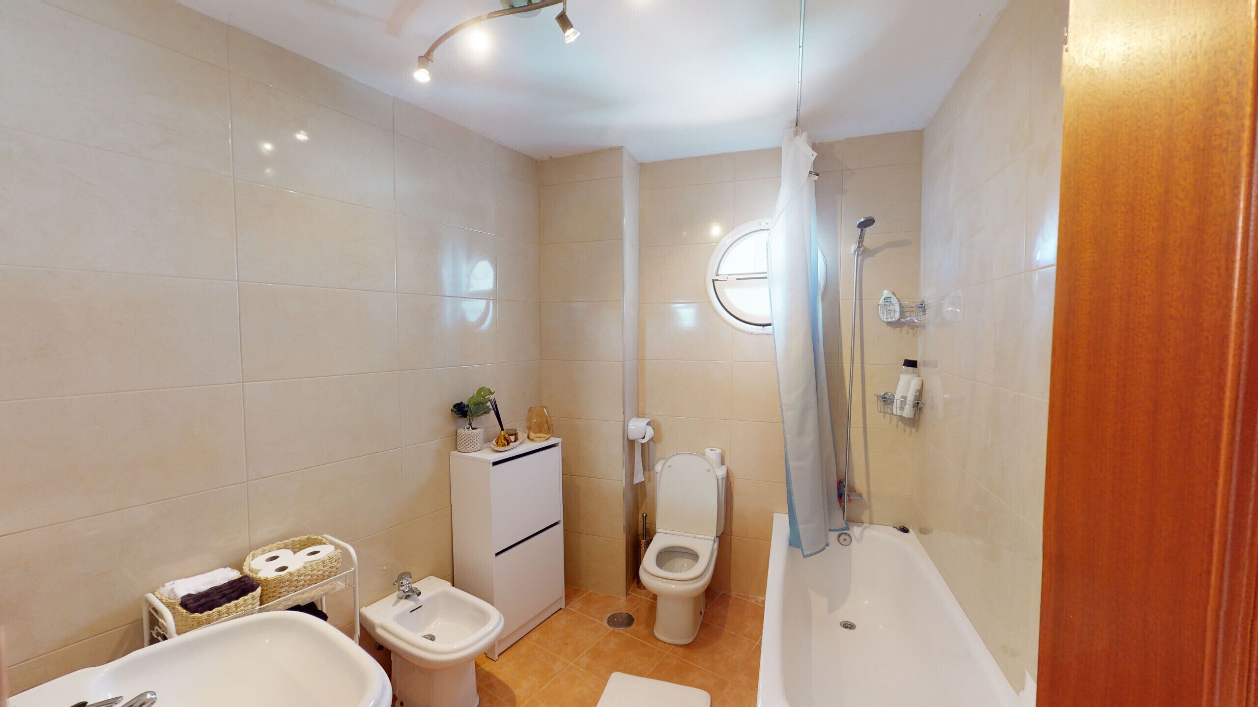 Une salle de bain moderne équipée d’une baignoire, d’un bidet, de toilettes et d’un lavabo.