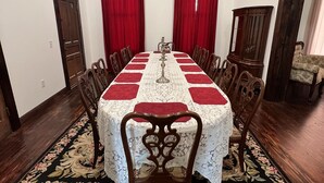 A dining room with a round table, red curtains, and a chandelier. - Plenty of space to relax! Near Turner falls, the lake & Crossbar Ranch. Sleeps 6 (Davis)