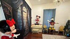 A room with a large window, a piano, a Christmas tree, and two animated character statues. - Plenty of space to relax! Near Turner falls, the lake & Crossbar Ranch. Sleeps 6 (Davis)