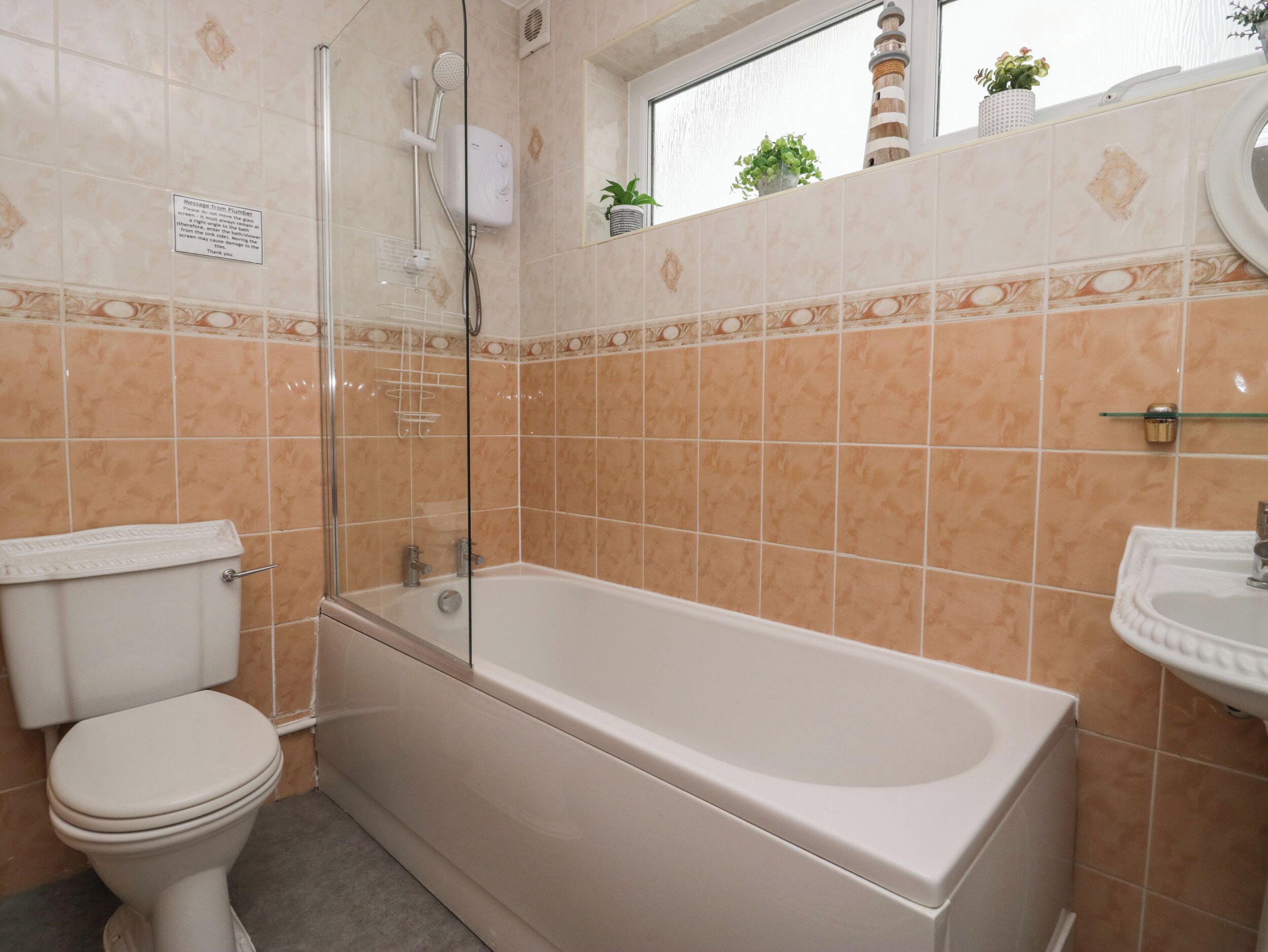 A bathroom with a bathtub, toilet, and sink.