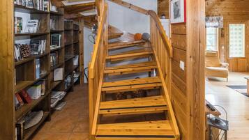 A wooden staircase in a room with bookshelves on either side.