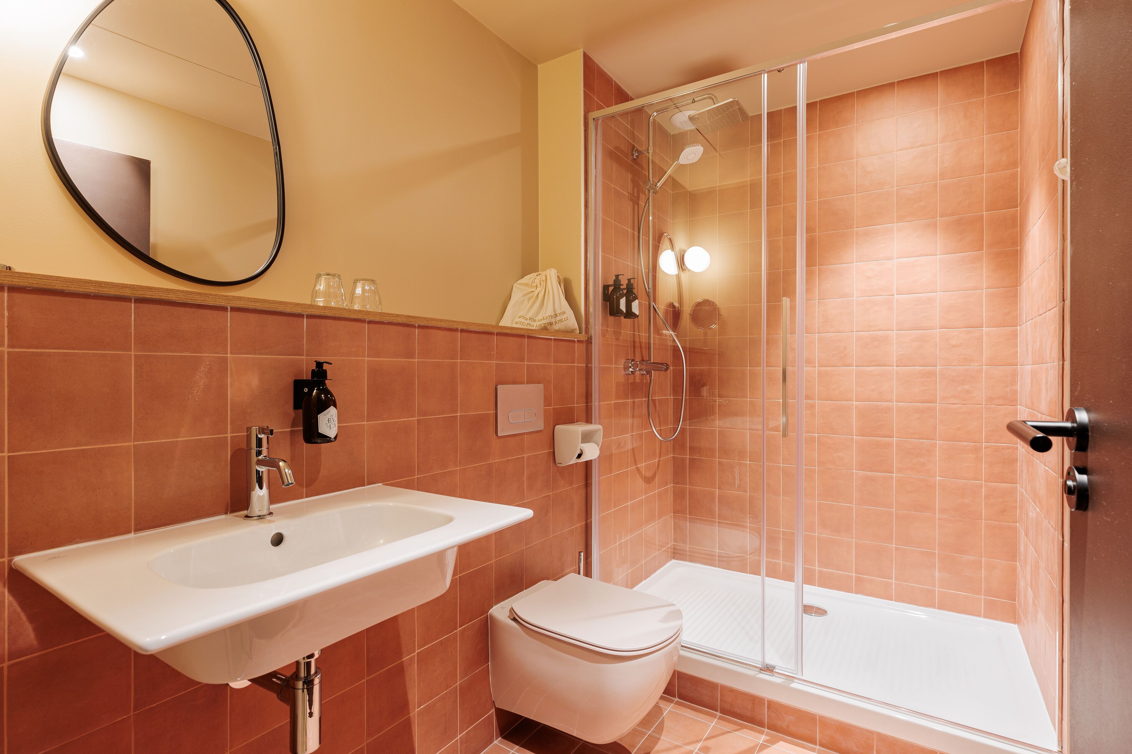 A bathroom with a sink, toilet, and shower.