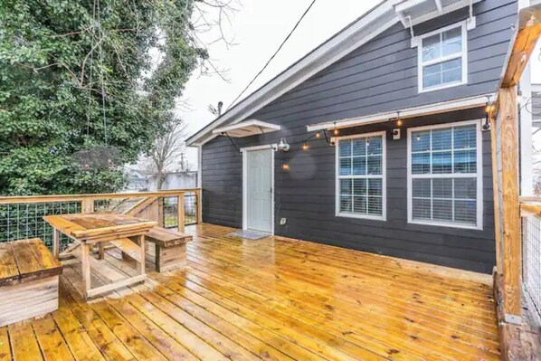 Enjoy outdoor dining or relaxation on the deck with a bench and table.