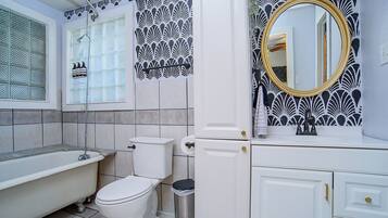 A bathroom with a bathtub, toilet, and sink.
