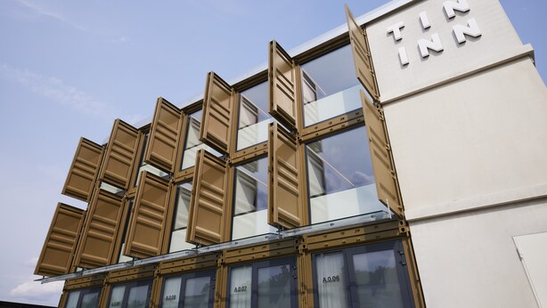 A building with a sign reading "TIN INN" and multiple windows with open shutters. - TIN INN Montabaur (Montabaur)