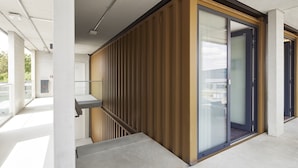 A modern building with a glass door, a concrete staircase, and a metal railing. - TIN INN Montabaur (Montabaur)