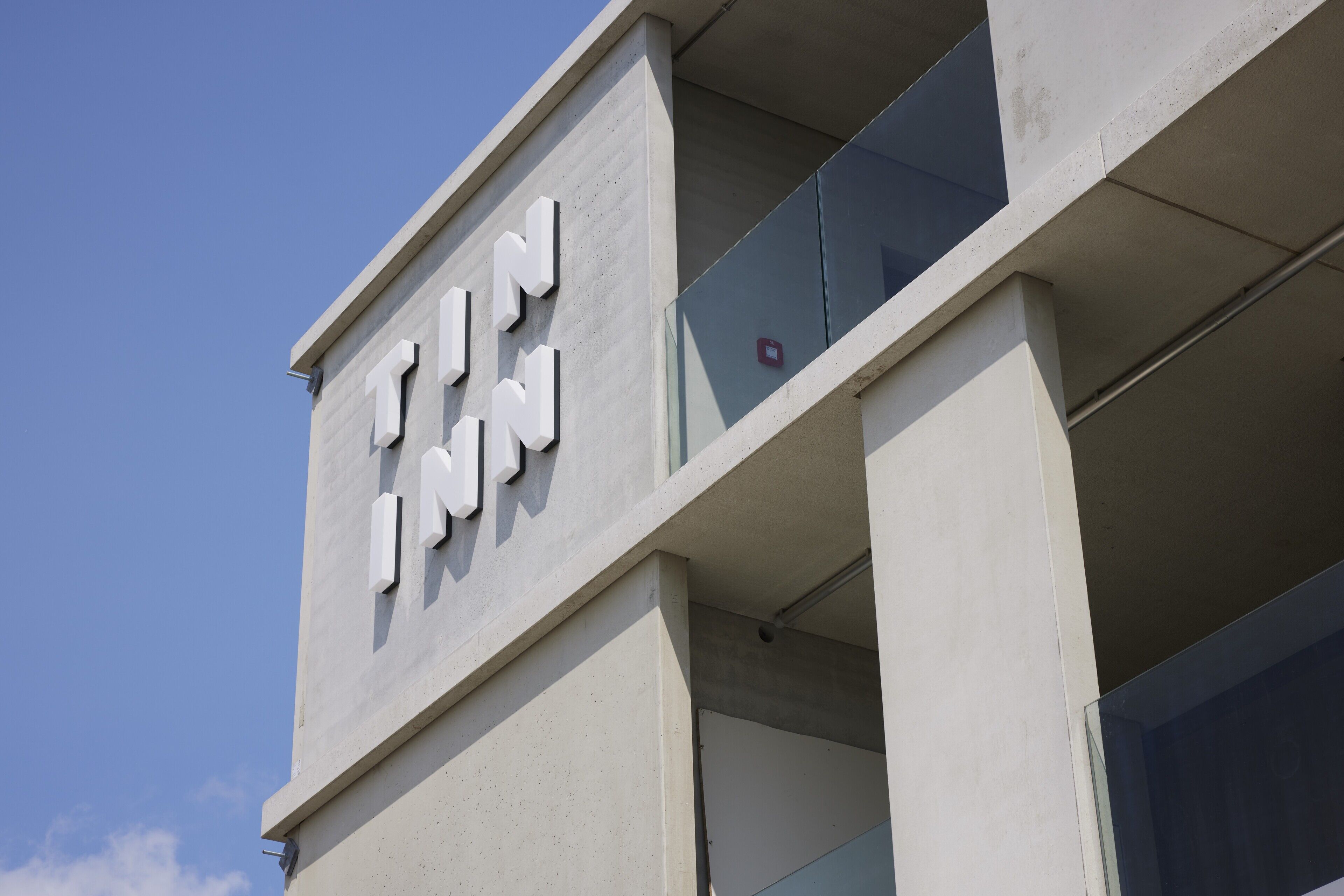 A building with the sign "TIN INN" indicating a hotel.