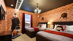 A hotel room with brick walls, two beds, a chandelier, and a wall-mounted owl decoration. - Spacious Family Getaway at Windsor Island Resort (Davenport)