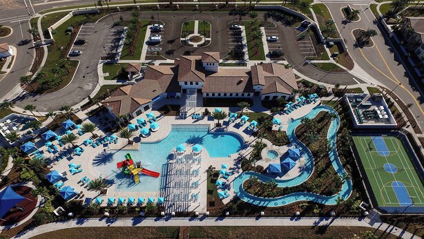 An aerial view of a resort with a swimming pool, sun loungers, a water slide, and a basketball court. - Special Offer Spacious Home With Pool! (Kissimmee)