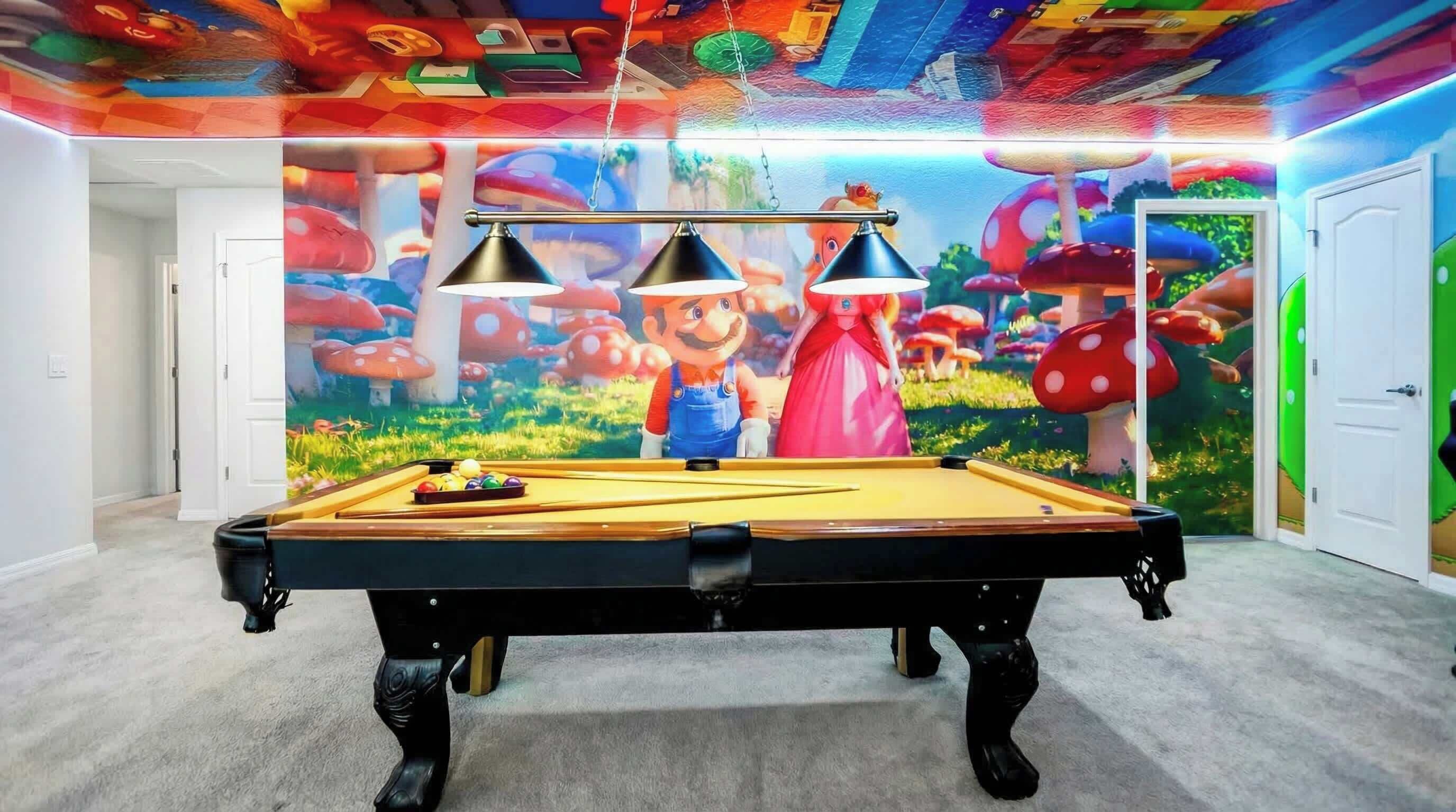 A pool table with a colorful mural in the background.