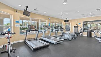 A gym with treadmills, elliptical machines, and weight equipment.