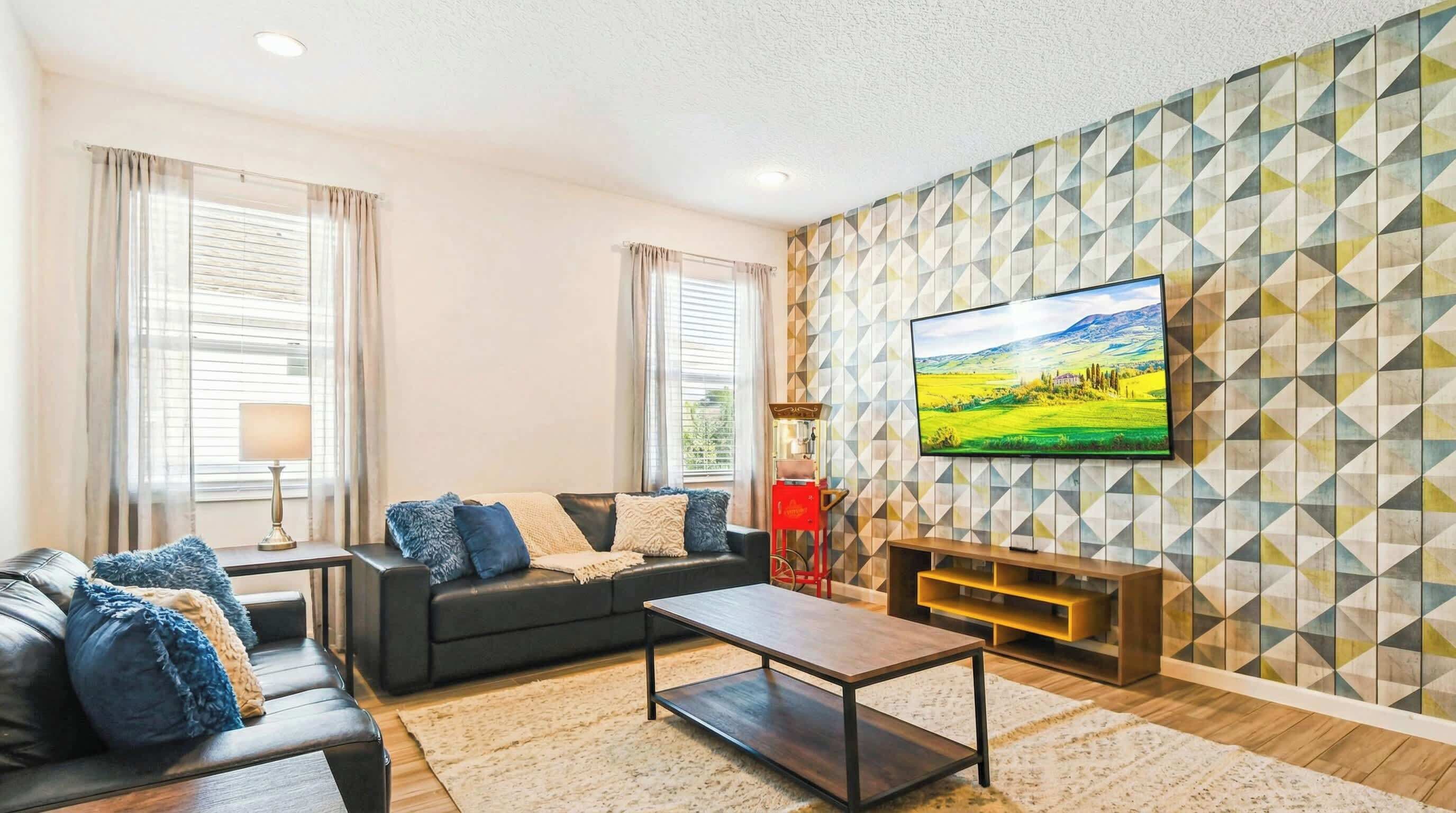 A modern living room with a sofa, coffee table, and TV.