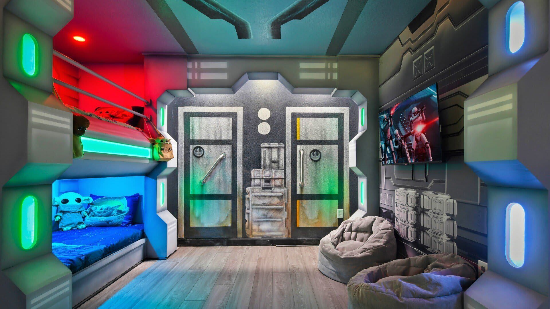 A room with a Star Wars theme, including a bed, a bean bag, and a wall with Star Wars characters.