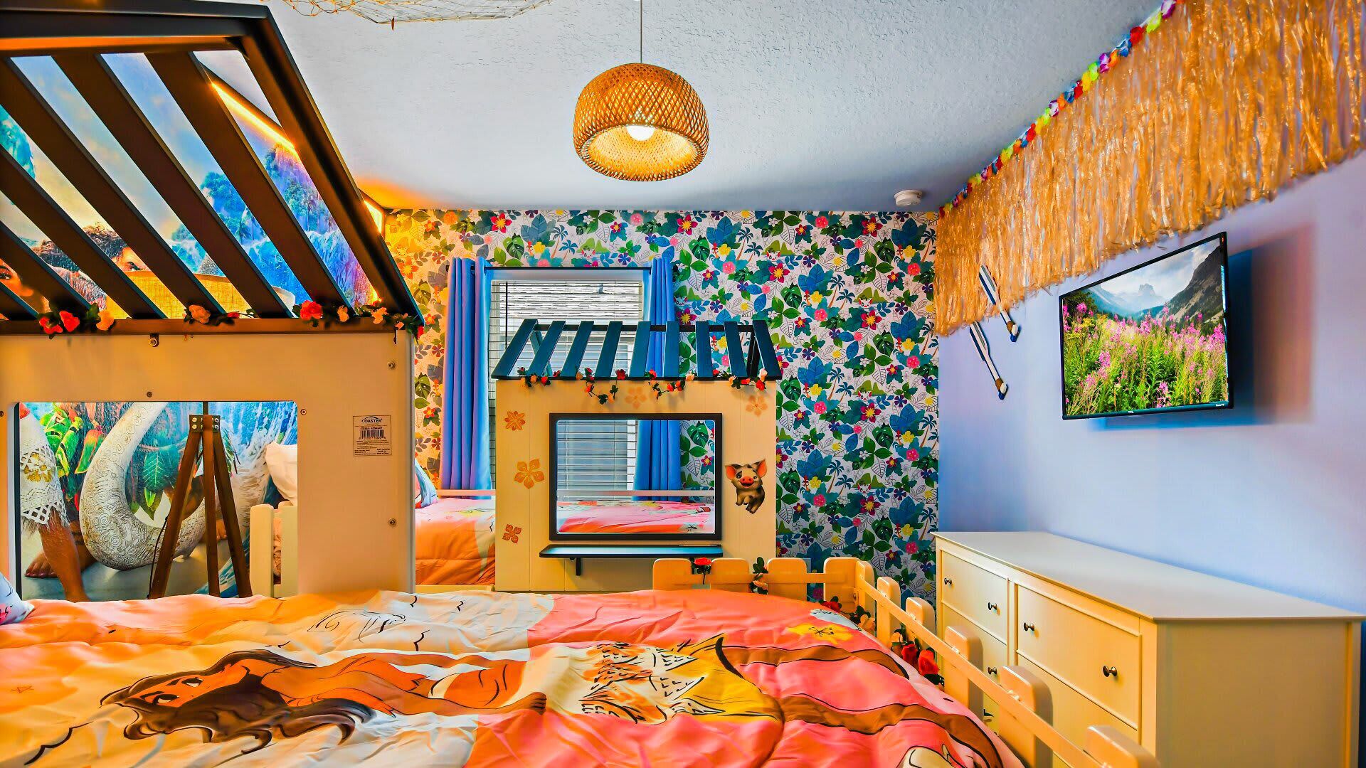 A colorful room with a bed, a desk, and a TV.