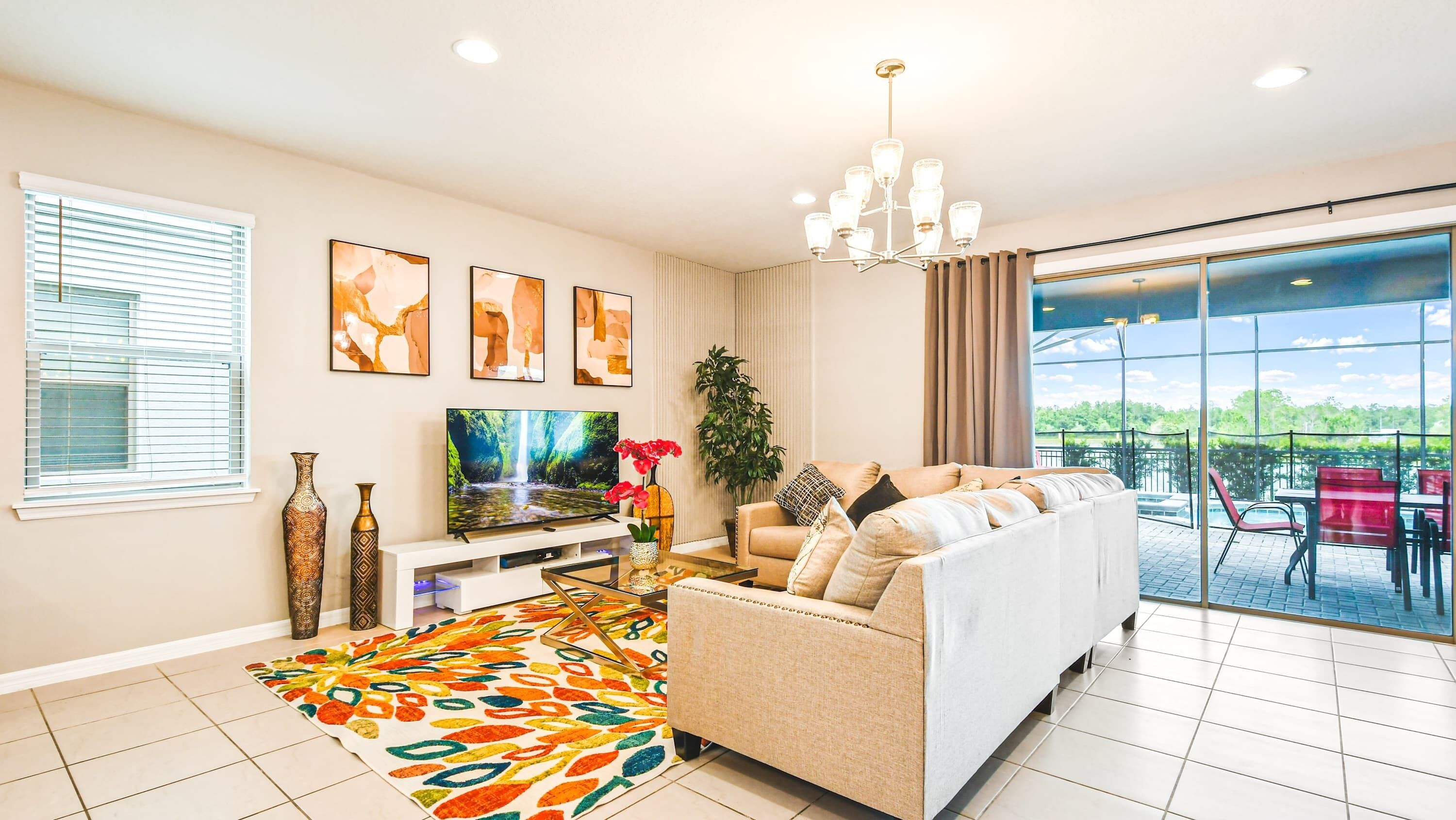 A modern living room with a sofa, TV, decorative vases, and artwork.