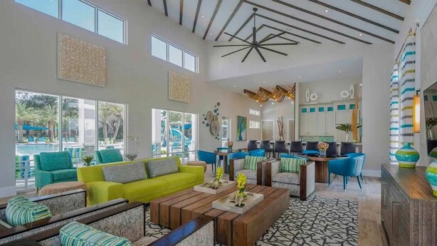 A spacious living area with a bright yellow sofa, multiple seating options, and a modern ceiling design. - Veranda Plams 9BR Villa Private Pool Spa 2570 (Kissimmee)