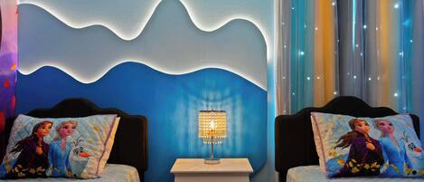 A bedroom with two beds, a nightstand, and a wall with a wave design.
