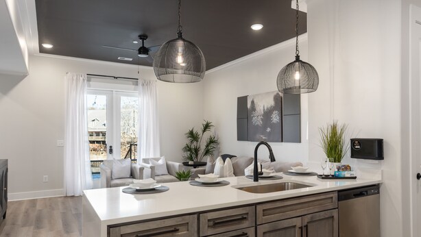 A modern kitchen with a large island, pendant lights, and a view to the outside. - 3 Bedroom, Main Level (Helena)