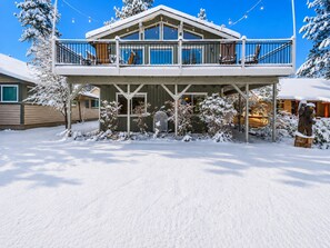 A two-story house with a covered porch and a balcony. - Cub Run Cabin (Big Bear Lake)