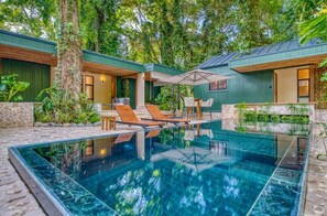 A modern outdoor pool area with a clear pool, lounge chairs, and a covered seating area. - BRAND NEW 5-Star LUXE The Oasis - Family Villa
 (Manzanillo)