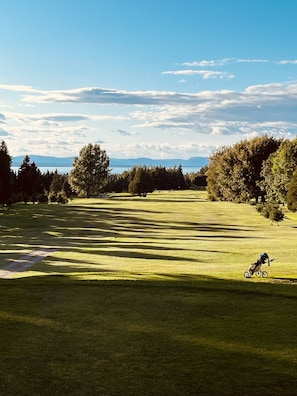 Enjoy a peaceful round of golf surrounded by lush trees and scenic views of the distant mountains.