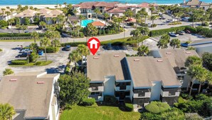 An aerial view of a coastal resort with multiple buildings, a pool, and a view of the ocean. - Gated community, private beach access, renovated condo!! (Ponte Vedra Beach)
