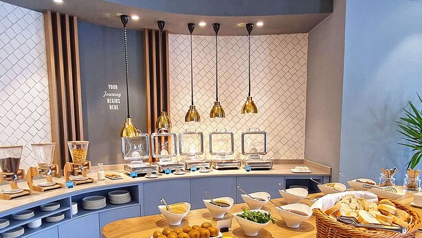 A buffet setup with various food items and serving stations. - Hampton By Hilton Sakarya (Serdivan)