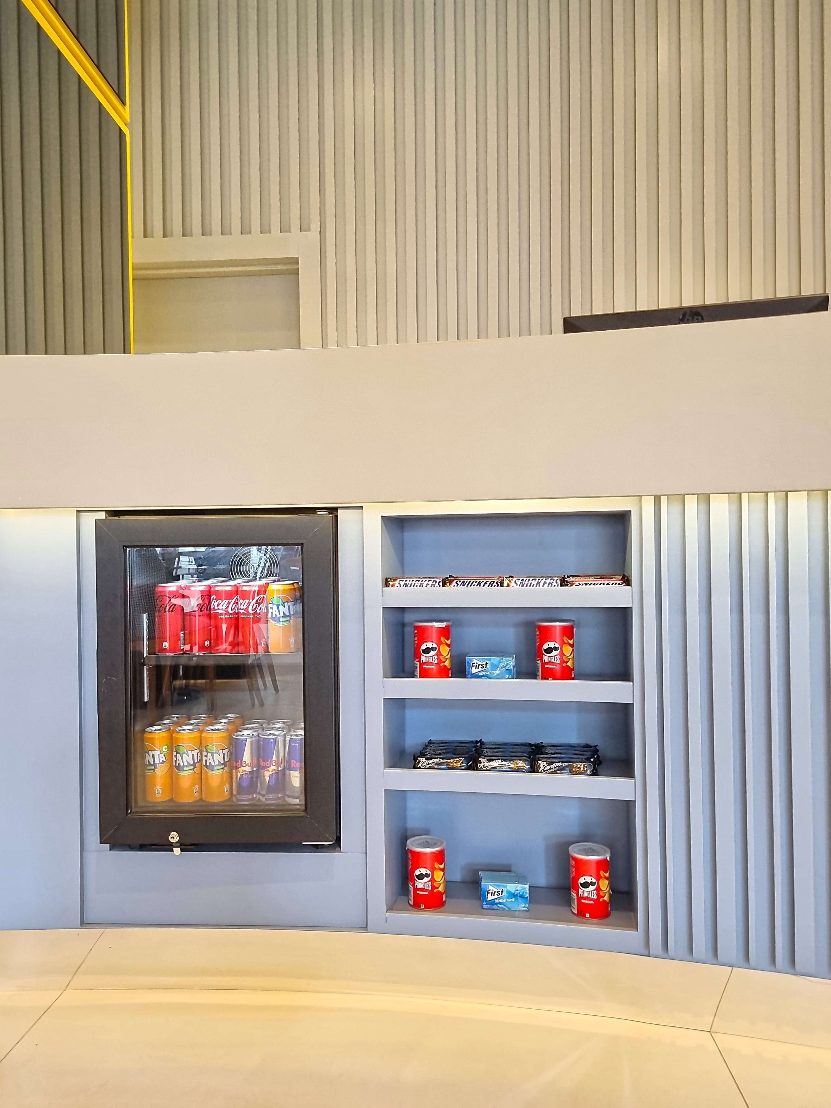 A vending machine with snacks and drinks, and shelves with packaged goods.