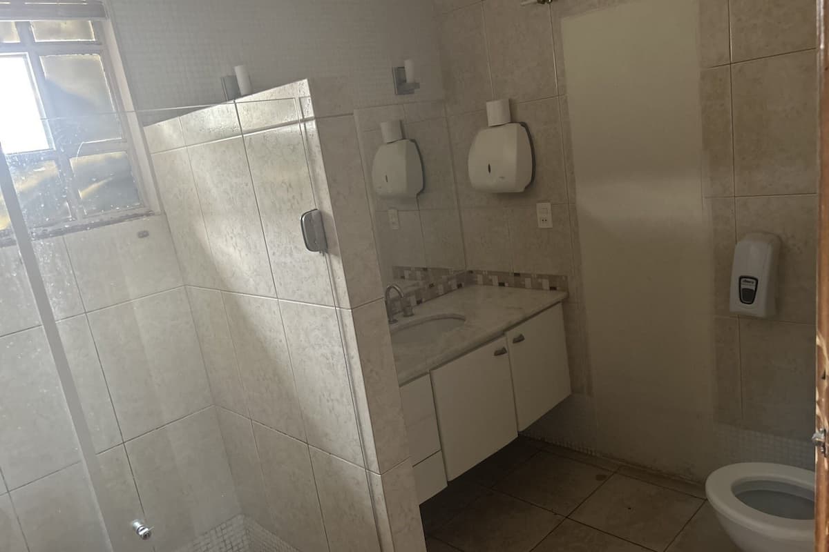 A bathroom with a shower, toilet, and sink.