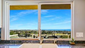 A kitchen with a large window offering a view of a cityscape and the ocean. - 25% Off Sept 7-9, Amazing Reviews/Views, Hot Tub! (Ventura)