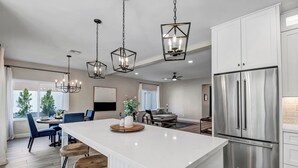 A modern kitchen with a central island, stainless steel appliances, and pendant lighting. - Paradise Villa - Spacious Home with Private Pool, Office, and Pool Table in Scottsdale (Scottsdale)