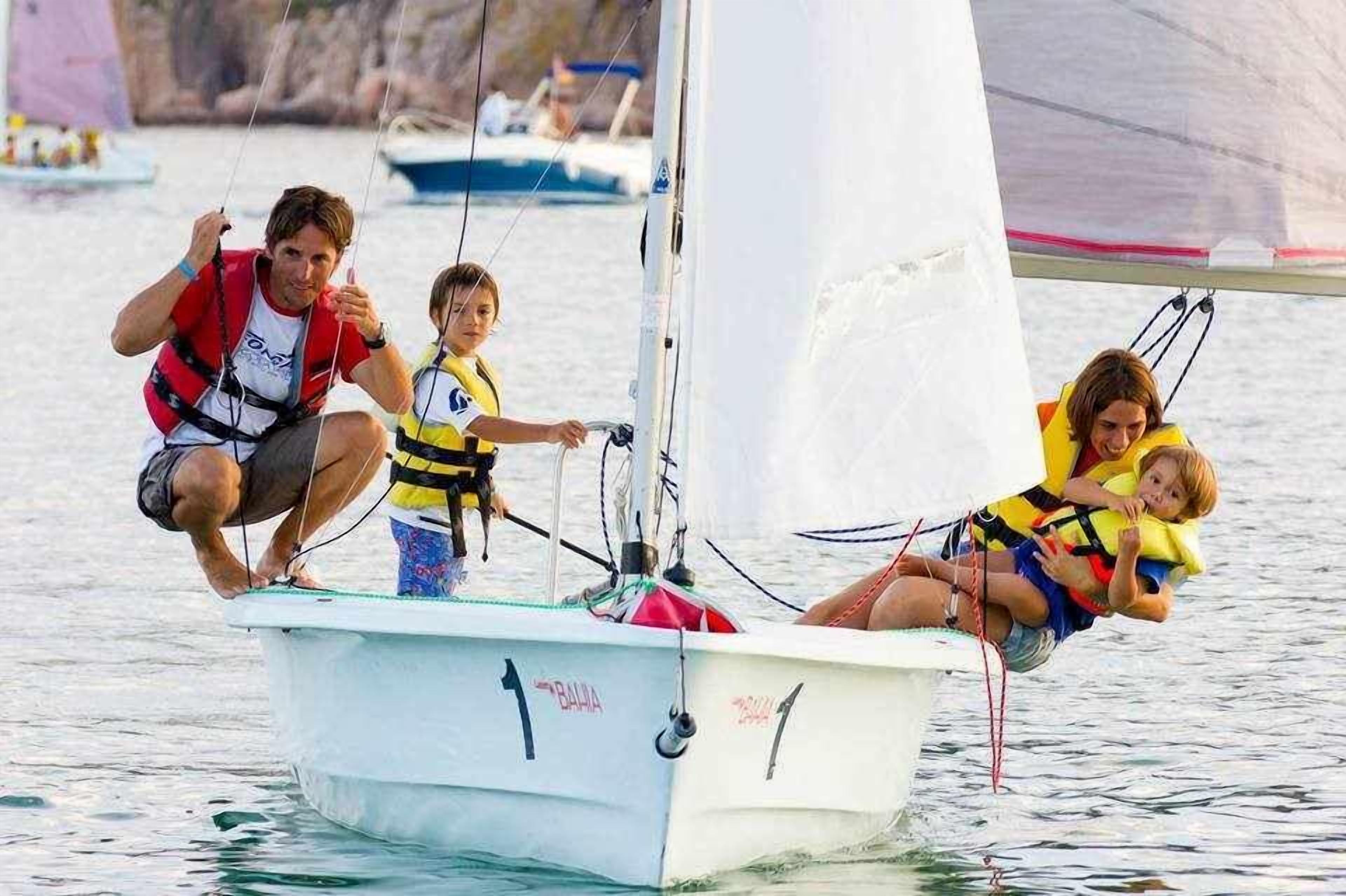 A sailboat with a white hull and a red and white sail.