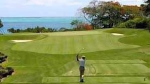 A golf course with a view of the ocean.
