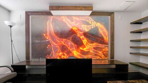 A modern room with a large lava flow artwork on the wall, a dark wooden table, and a floor lamp. - Stylish 1 bedroom basement unit with renovated bathroom & in-suit Jacuzzi. (Richmond Hill)