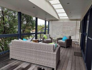 Spacious deck with ocean views accessed by interal and external stairs