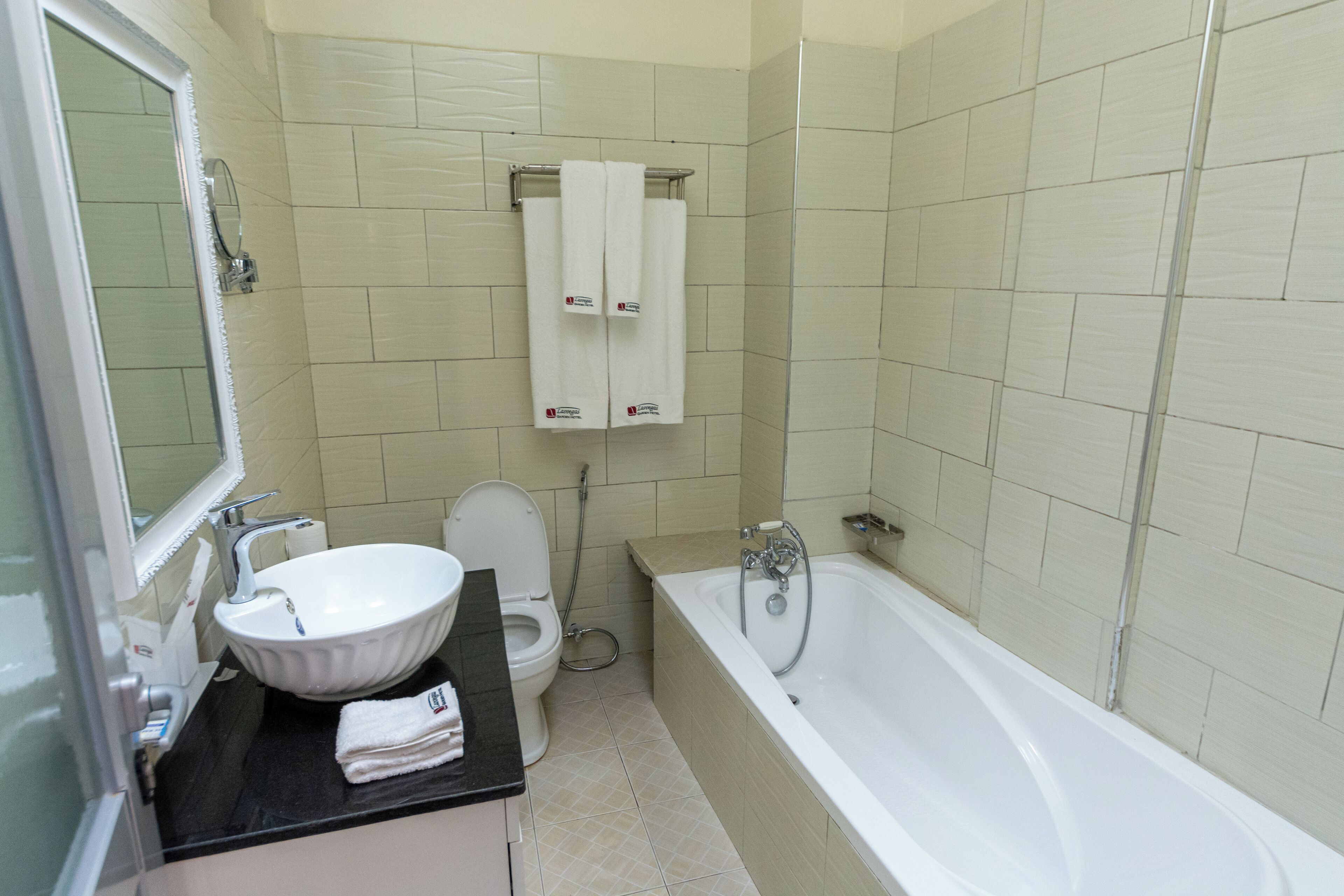 A bathroom with a sink, toilet, and bathtub.