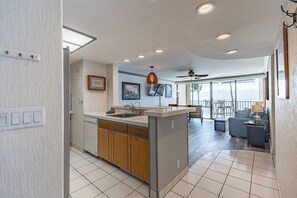 Enjoy meals in the kitchen with a central island and oven, surrounded by a dining area with a table and chairs.