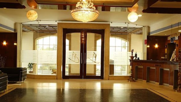 A spacious lobby with a grand chandelier, double doors, and a reception desk. - Fabhotel Prime Chennai Deluxe (Chennai)