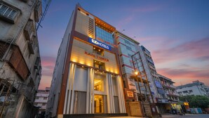 A hotel with a modern facade, a prominent entrance, and a sign indicating it is a Ram Tower hotel. - Fabhotel Rani Tower (Barasat)